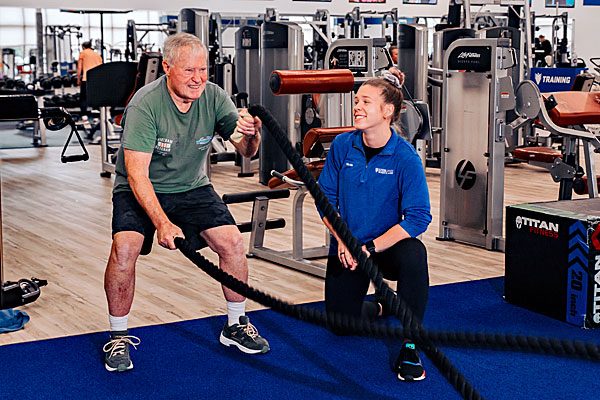 Senior man doing a workout with a personal trainer at West Conshy Athletic Center.